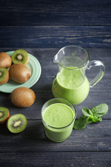 Delicious yogurt smoothie with kiwi  on wooden background