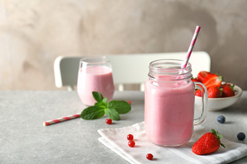 Delicious yogurt smoothie with strawberry  on table