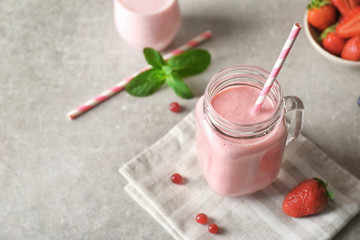 Delicious yogurt smoothie with strawberry  on table