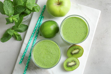 Delicious yogurt smoothie with apple and kiwi on light table