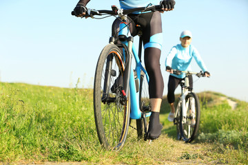 Obraz premium Sporty cyclists riding bicycles in countryside