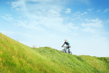 Sporty cyclist riding bicycle in countryside