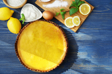 Composition with tasty lemon curd pie on wooden table