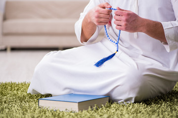 Arab man praying at home