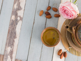 tea set and almon nut on old wood background