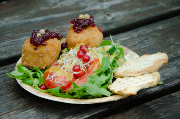Vegetable salad with cheese and cranberry jam