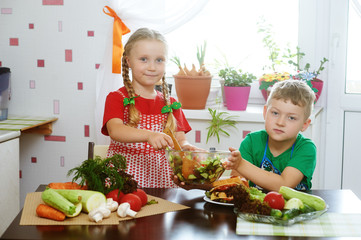 Children prepare salad vegetables . Happy kids in the kitchen . The concept of a healthy wholesome food