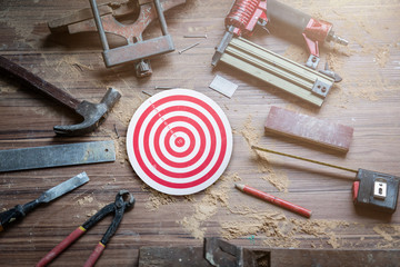 dart goal on wooden floor with hand tool carpenter