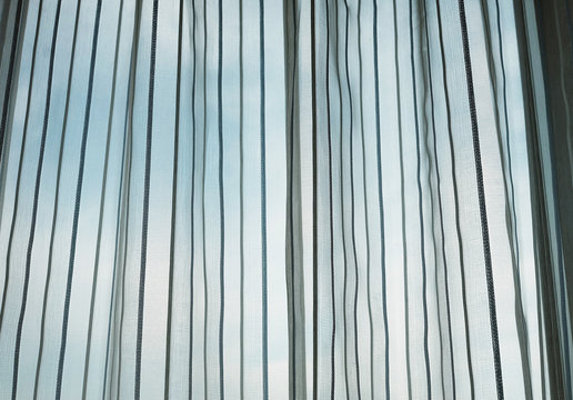 Window with curtain and blue sky