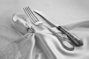 Vintage cutlery on white silk