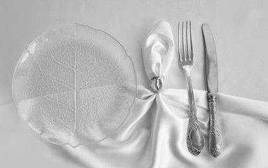 Vintage cutlery on white silk