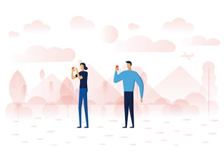 A men and A women are standing in the park and taking a photo by smartphones.