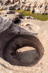 The stone hole caused by the water erode in Mekhong river after the water drops in summer,the...