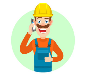 Builder talking on mobile phone and showing thumb up