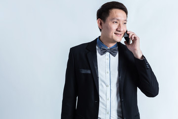 Naklejka premium smart asian business man in suit and use smartphone on white background