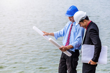 engineer and business man meeting and checking site outdoor business concept