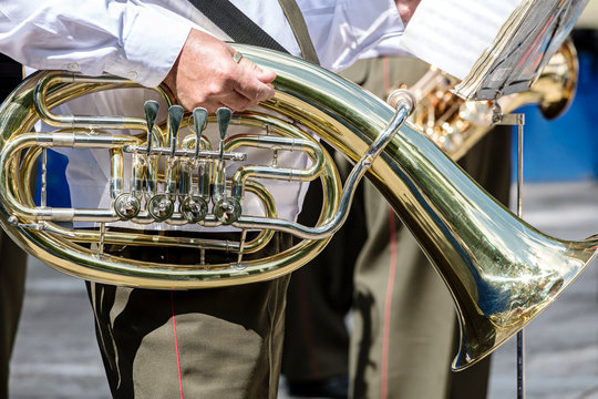 musician of military brass orchestra holding tuba in his hand