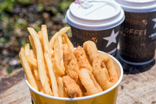 French fries and nagets for breakfast in nature with coffee