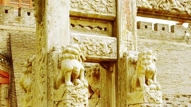 China stone arch & stone lions in front of ancient city gate.