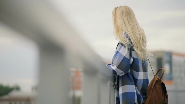 Sad woman looking to cityscape