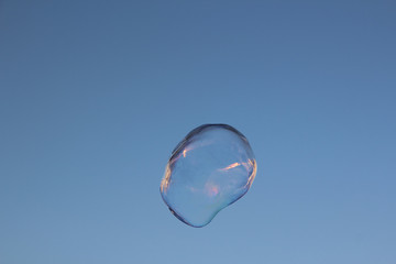 Soap bubble on the sky background
