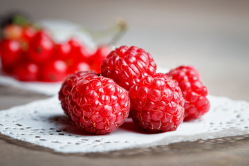 Ripe raspberries on a wooden table.