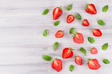 Colorful summer fruit background with slice strawberry and mint leaf, top view.  Decorative border with copy space.