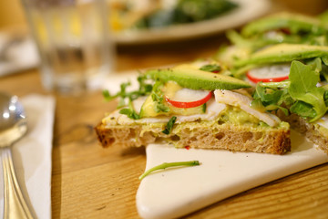 whole wheat bread slice with avocado and radish