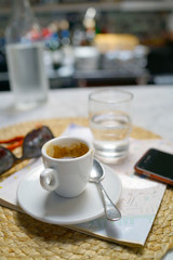 Coffee cup and city map on restaurant table