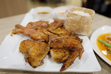 Grilled chicken with Papaya spicy salad and sticky rice (Kaiyang Somtum) Thai food.