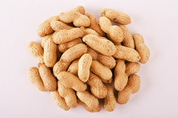 Roasted inshell peanuts scattered