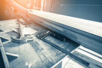 construction concept with old wood tools with wood workshop and light flare effect with color tome...