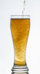 Light beer pours into a glass