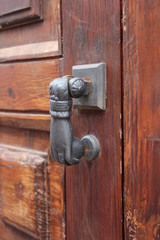 designer metal handle on wooden door