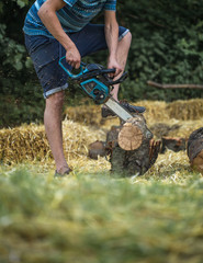 Man chopping wood with a chainsaw