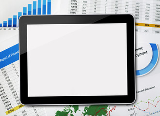 Digital tablet on financial papers
