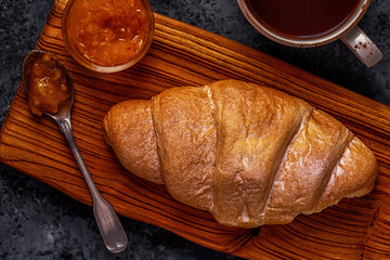 Fresh croissant on dark background.