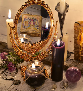 Close up with magic mirror and black candles