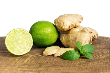 detail of whole and cut fresh ginger with lime