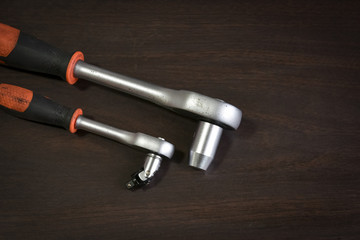 ratchet wrench lying on wooden table