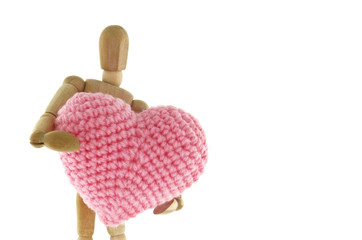 Wooden mannequin hugging heart knit with yarn