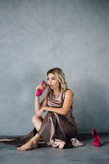 young woman in purple dress sitting on a floor