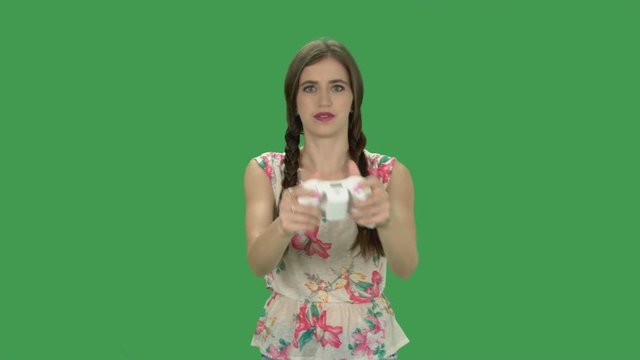 Young woman play videogames on a Xbox Console using an white Xbox Controller. Satisfaction and Victory is the final action