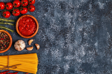 Italian food background with pasta, spices and vegetables.