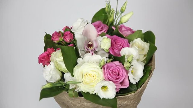 Bouquet of roses, eustoma and orchids on white background