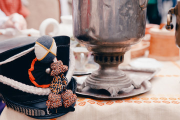 Hat of the Russian hussar headpiece on the table, in the background samovar