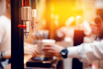 Master spills on the glasses lemonade and soda water in the glasses. Close-up. Concept of draft beverages.