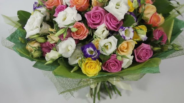 Pink roses and eustoma bouquet in green packging