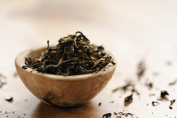 golden orchid tea in small bowl on wood table