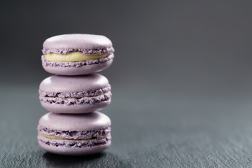 Fototapeta na wymiar lavender purple macarons stacked on slate board